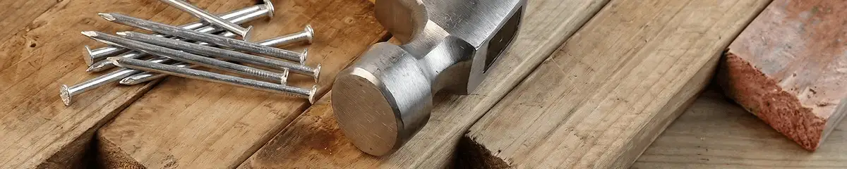 Hammer and nails on hardwood flooring boards in Albany, NY