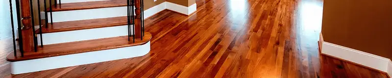 Base floor of a staircase with professionally restored wood flooring in Albany NY