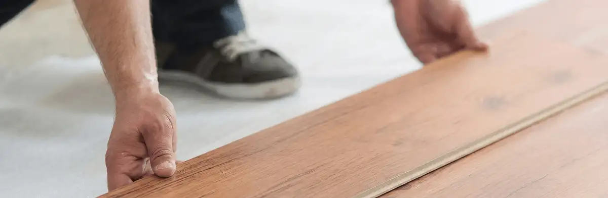 A professional installing laminate flooring in Albany, NY